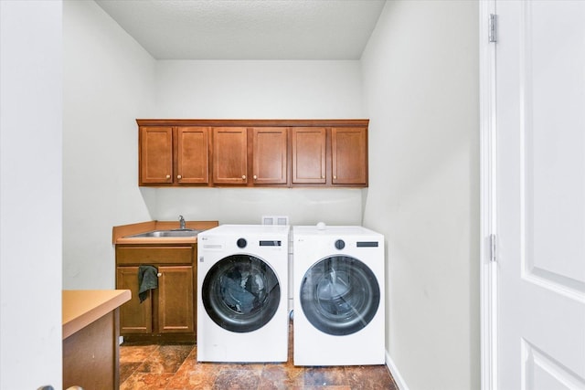 412 Doisy Ln, Champaign, IL 61822 - laundry area featuring cabinet space, washing machine and clothes dryer, stone finish floors, and a textured ceiling