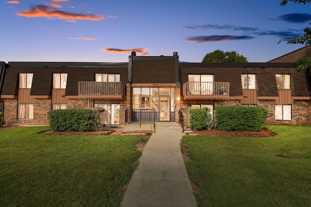717 Tipperary Ct Unit 2B, Schaumburg, IL 60193 - view of property featuring brick siding, a balcony, and a front yard