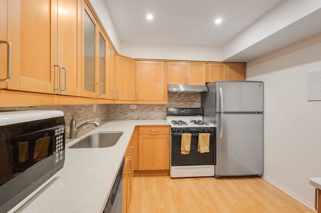 717 Tipperary Ct Unit 2B, Schaumburg, IL 60193 - kitchen with appliances with stainless steel finishes, under cabinet range hood, backsplash, light countertops, and light wood finished floors