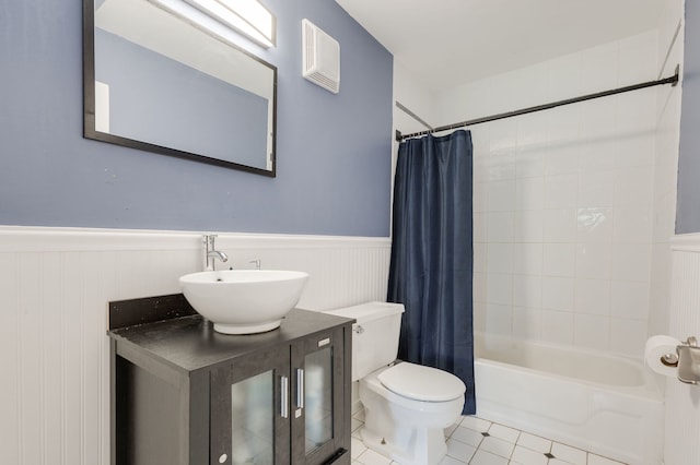 717 Tipperary Ct Unit 2B, Schaumburg, IL 60193 - bathroom with a wainscoted wall, tile patterned flooring, shower / bath combo with shower curtain, and vanity