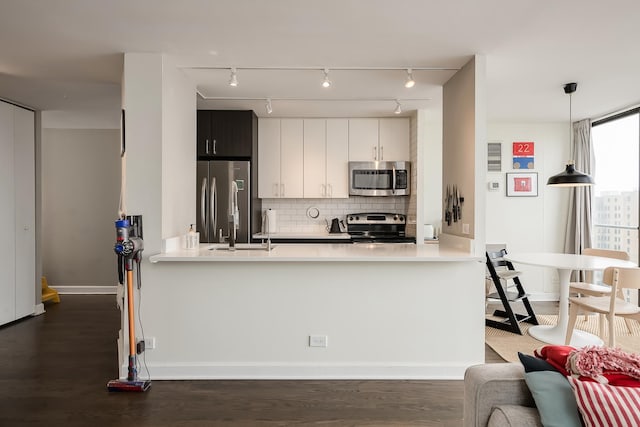 345 W Fullerton Pkwy Unit 1706, Chicago, IL 60614 - kitchen with stainless steel appliances, a peninsula, backsplash, and light countertops