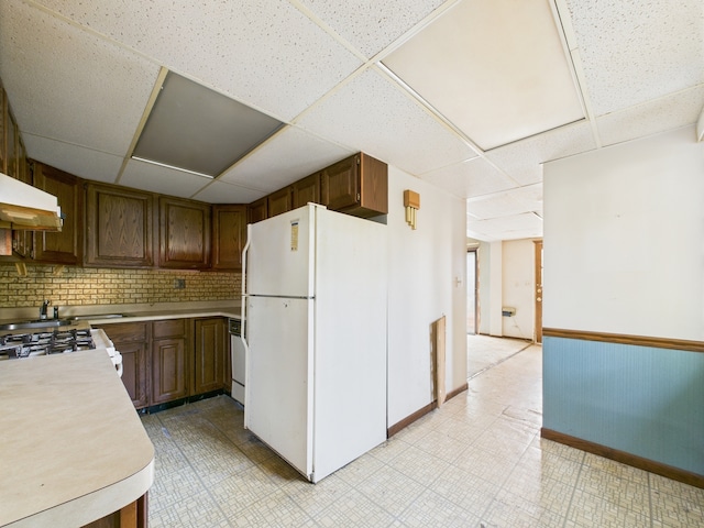 2404 Sigwalt St, Rolling Meadows, IL 60008 - kitchen with freestanding refrigerator, a paneled ceiling, light countertops, range with gas stovetop, and backsplash