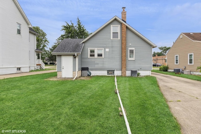 527 W Green St, Bensenville, IL 60106 - back of house featuring a chimney, a shingled roof, and a yard