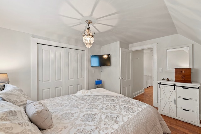 506 E Russell St, Barrington, IL 60010 - bedroom featuring dark wood-type flooring, a closet, vaulted ceiling, and a chandelier