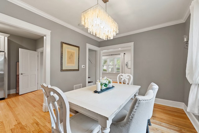 506 E Russell St, Barrington, IL 60010 - dining area with a chandelier, light wood-style flooring, and crown molding