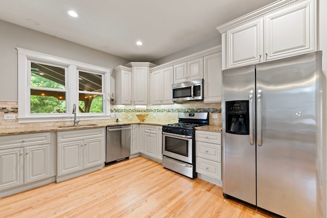 506 E Russell St, Barrington, IL 60010 - kitchen with appliances with stainless steel finishes, tasteful backsplash, light stone counters, light wood-style floors, and recessed lighting