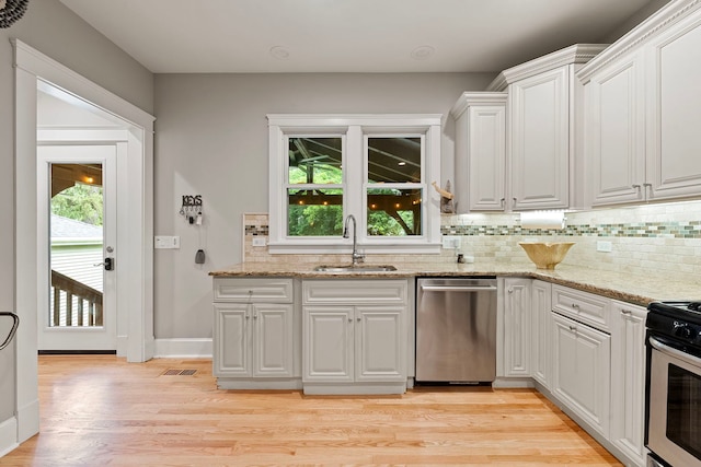 506 E Russell St, Barrington, IL 60010 - kitchen with appliances with stainless steel finishes, decorative backsplash, white cabinetry, light wood-style flooring, and light stone counters
