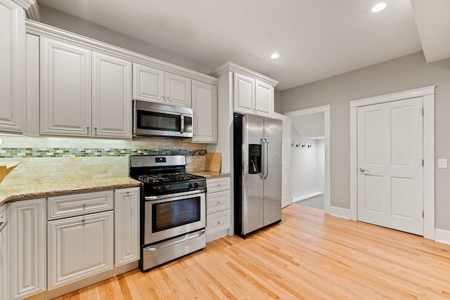 506 E Russell St, Barrington, IL 60010 - kitchen featuring stainless steel appliances, tasteful backsplash, light wood-type flooring, recessed lighting, and light stone countertops