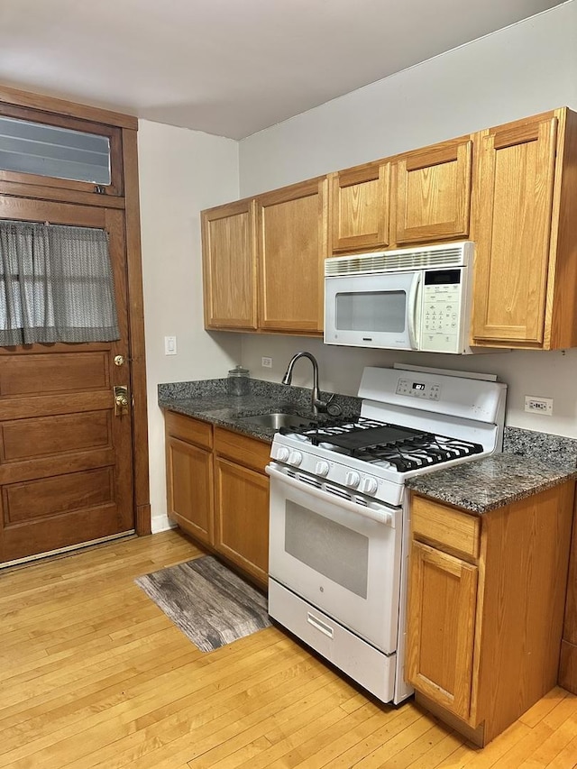 3514 N Lawndale Ave Unit 2, Chicago, IL 60618 - kitchen with white appliances, light wood-type flooring, and dark stone counters