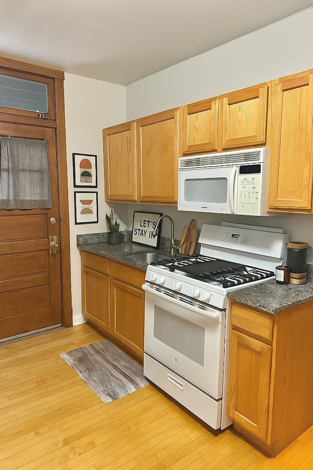 3514 N Lawndale Ave Unit 2, Chicago, IL 60618 - kitchen with white appliances, light wood-style flooring, and dark countertops