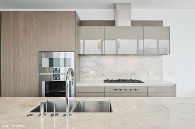 363 E Wacker Dr Unit 6501, Chicago, IL 60601 - kitchen with backsplash, light stone countertops, modern cabinets, and stainless steel gas cooktop
