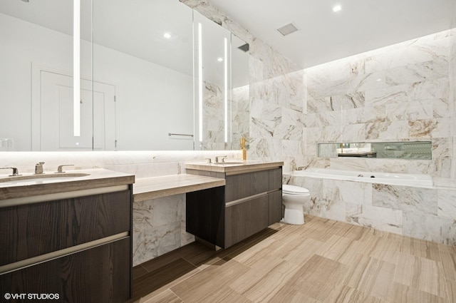 363 E Wacker Dr Unit 6501, Chicago, IL 60601 - bathroom featuring vanity, a garden tub, and wood finished floors
