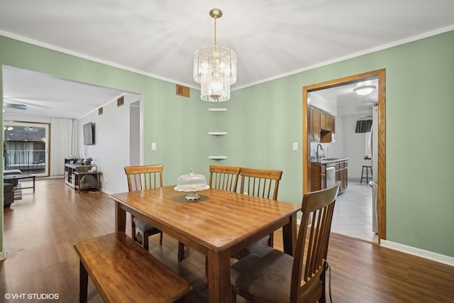 9377 Landings Ln Unit 502, Des Plaines, IL 60016 - dining space with a chandelier, wood finished floors, and ornamental molding