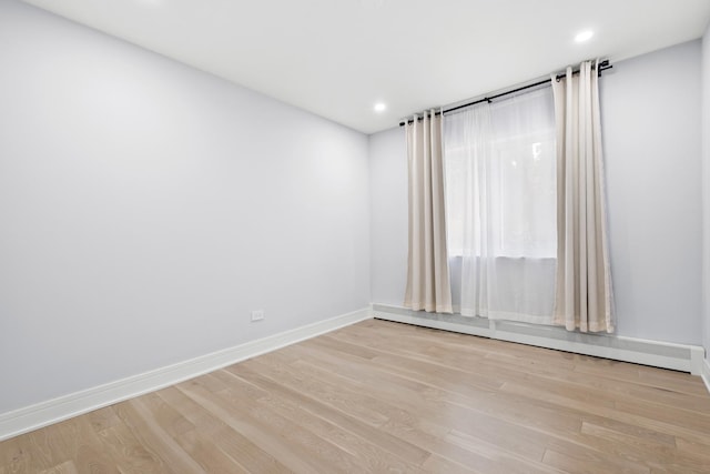 974 Crabapple Dr Unit 308, Prospect Heights, IL 60070 - empty room with a baseboard radiator, light wood finished floors, and recessed lighting