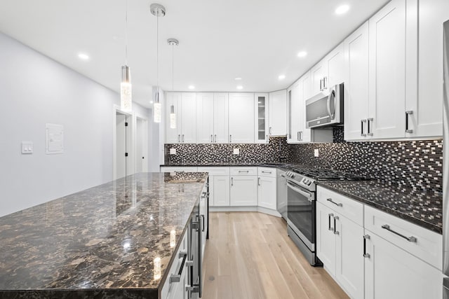 974 Crabapple Dr Unit 308, Prospect Heights, IL 60070 - kitchen with appliances with stainless steel finishes, light wood-type flooring, a kitchen island, recessed lighting, and tasteful backsplash