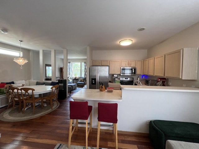 163 Mountain Laurel Ct, Romeoville, IL 60446 - kitchen with stainless steel appliances, open floor plan, a peninsula, light brown cabinetry, and light countertops