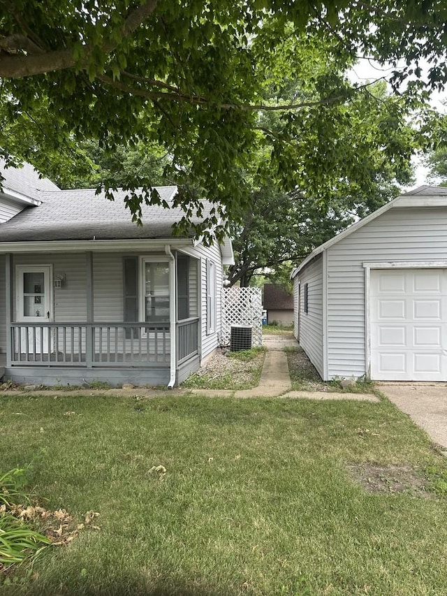201 E N St, Saybrook, IL 61770 - view of home's exterior with a porch, a lawn, a garage, and a shingled roof