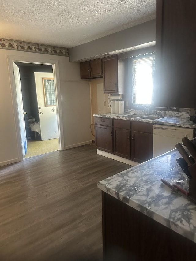 201 E N St, Saybrook, IL 61770 - kitchen featuring white dishwasher, a textured ceiling, dark wood-type flooring, and light countertops