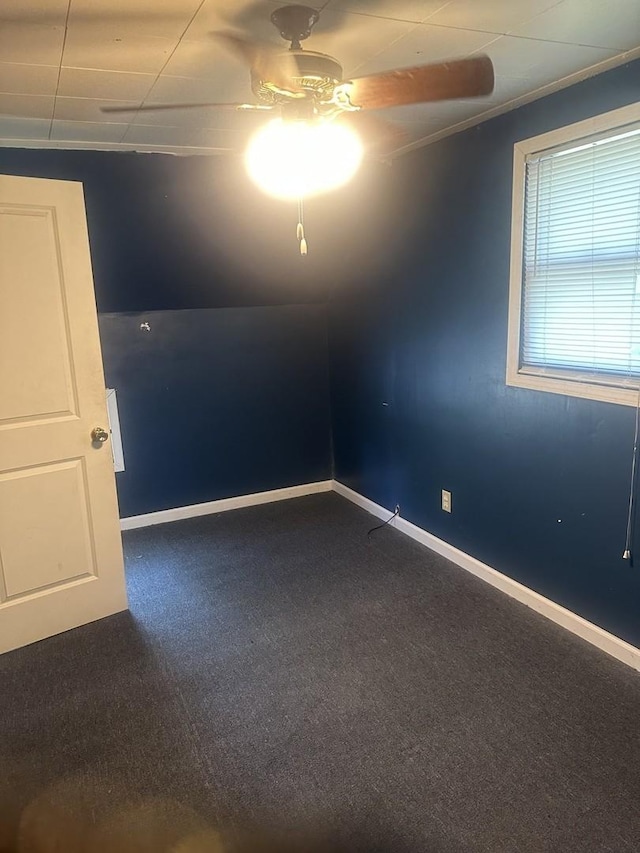 201 E N St, Saybrook, IL 61770 - empty room with dark colored carpet and ceiling fan