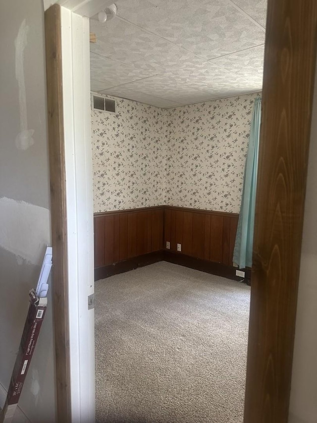 201 E N St, Saybrook, IL 61770 - empty room featuring a wainscoted wall, carpet floors, and wallpapered walls