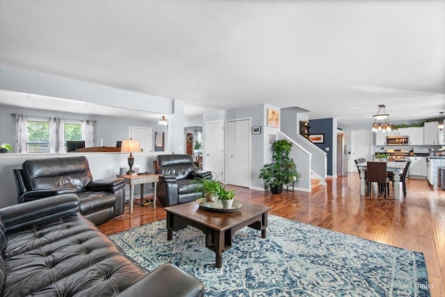 243 Johnson St, Hampshire, IL 60140 - living room with light wood-style floors, stairs, and a chandelier