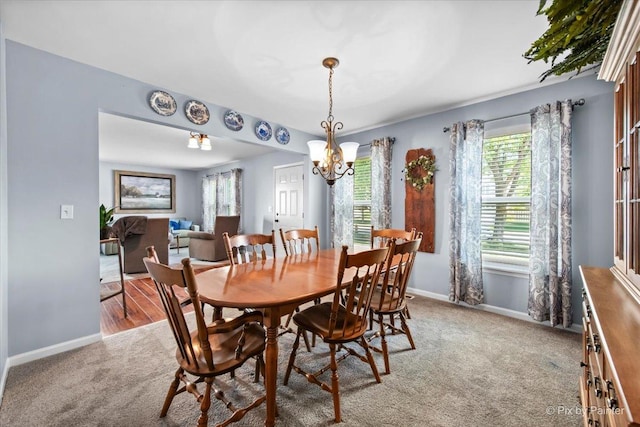 243 Johnson St, Hampshire, IL 60140 - dining room with light colored carpet, healthy amount of natural light, and a chandelier