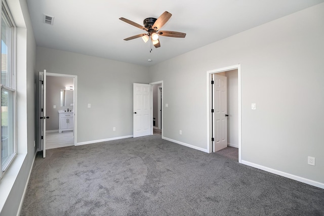 121 Pine St, Buckingham, IL 60917 - unfurnished bedroom with dark colored carpet, connected bathroom, and a ceiling fan