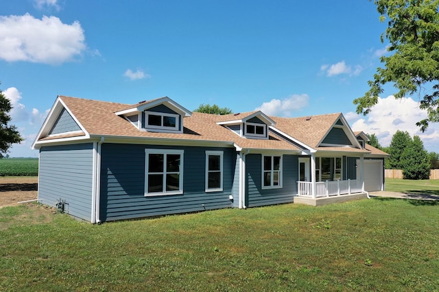 121 Pine St, Buckingham, IL 60917 - view of front of house with a front lawn, an attached garage, a shingled roof, a porch, and driveway