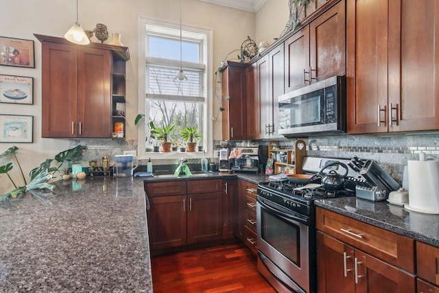 3234 N California St Unit 3S, Chicago, IL 60618 - kitchen with stainless steel appliances, crown molding, dark stone counters, decorative backsplash, and hanging light fixtures