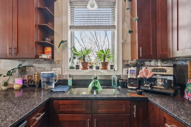 3234 N California St Unit 3S, Chicago, IL 60618 - kitchen featuring backsplash, dark stone countertops, and reddish brown cabinets