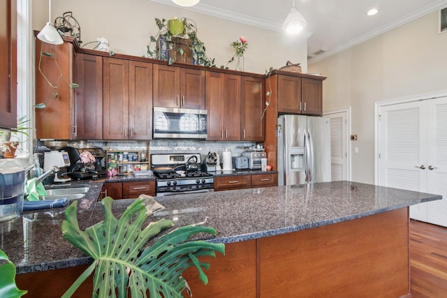3234 N California St Unit 3S, Chicago, IL 60618 - kitchen with stainless steel appliances, decorative backsplash, crown molding, dark stone countertops, and dark wood-type flooring