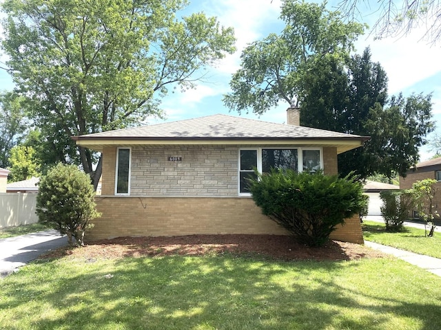 16009 Debbie Ln, South Holland, IL 60473 - view of side of home with a chimney, a lawn, and stone siding