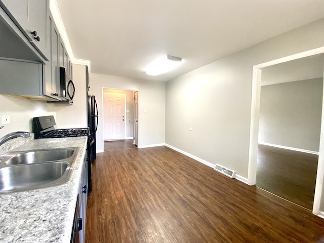 16009 Debbie Ln, South Holland, IL 60473 - kitchen featuring range with gas stovetop, dark wood finished floors, and freestanding refrigerator