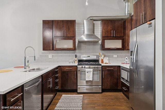 17 N Loomis St Unit 1C, Chicago, IL 60607 - kitchen with stainless steel appliances, wall chimney range hood, a peninsula, dark wood-style flooring, and light countertops