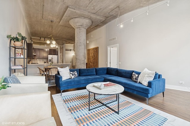17 N Loomis St Unit 1C, Chicago, IL 60607 - living room featuring wood finished floors, decorative columns, and a high ceiling