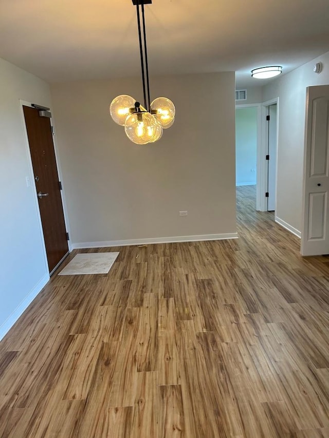 200 Park Ave Unit 634, Calumet City, IL 60409 - unfurnished room with wood finished floors, a chandelier, and a smoke detector