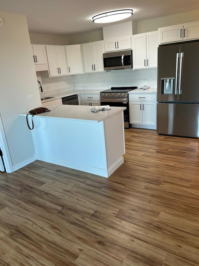 200 Park Ave Unit 634, Calumet City, IL 60409 - kitchen featuring appliances with stainless steel finishes, white cabinetry, backsplash, and wood finished floors