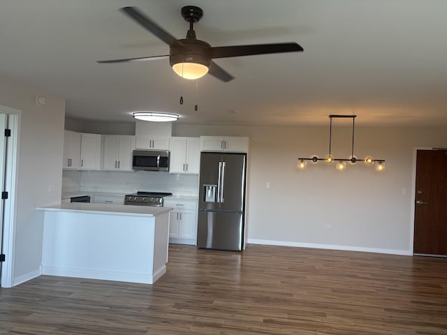 200 Park Ave Unit 634, Calumet City, IL 60409 - kitchen with appliances with stainless steel finishes, decorative backsplash, white cabinets, a ceiling fan, and dark wood-style flooring