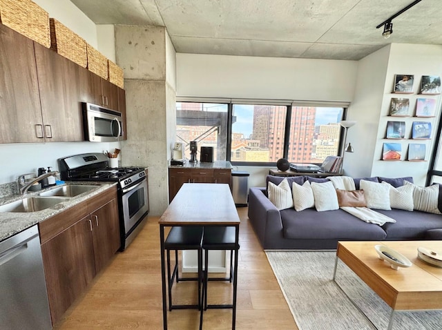235 W Van Buren St Unit 1703, Chicago, IL 60607 - kitchen featuring stainless steel appliances, light wood finished floors, a view of city, and open floor plan