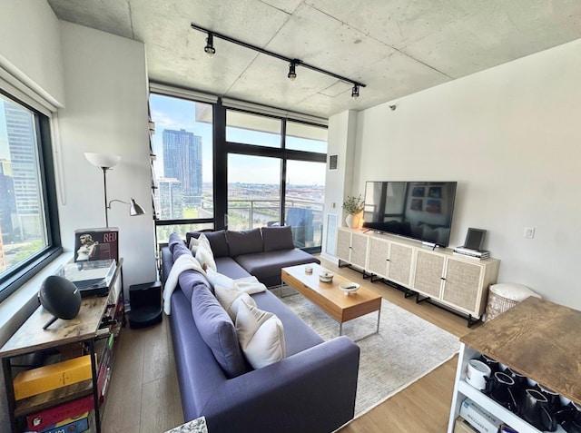 235 W Van Buren St Unit 1703, Chicago, IL 60607 - living area featuring rail lighting, wood finished floors, and healthy amount of natural light