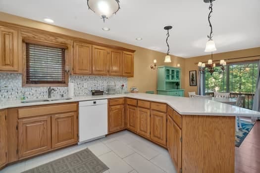 16620 Grants Trl, Orland Park, IL 60467 - kitchen with white dishwasher, light countertops, a peninsula, tasteful backsplash, and recessed lighting