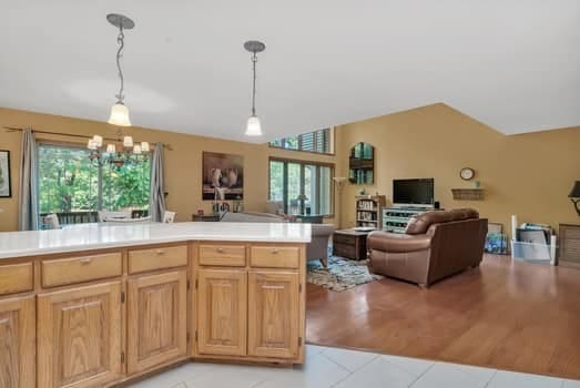 16620 Grants Trl, Orland Park, IL 60467 - kitchen featuring light tile patterned floors, open floor plan, light countertops, hanging light fixtures, and vaulted ceiling