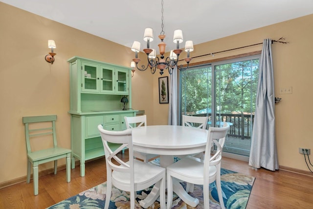 16620 Grants Trl, Orland Park, IL 60467 - dining area with a chandelier and light wood-style flooring