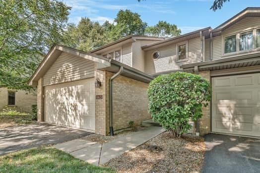16620 Grants Trl, Orland Park, IL 60467 - view of front of property with an attached garage, brick siding, and asphalt driveway