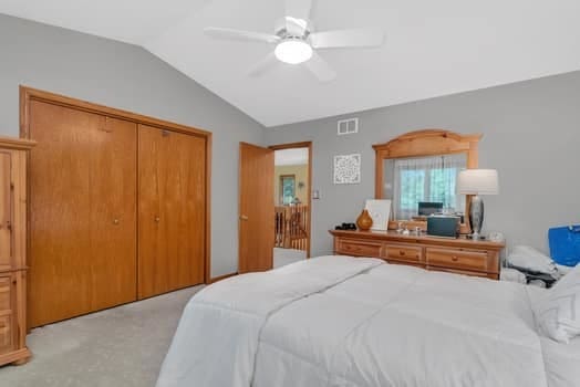 16620 Grants Trl, Orland Park, IL 60467 - bedroom featuring lofted ceiling, light carpet, a closet, and a ceiling fan