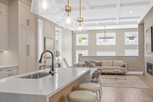 1642 W Wolfram St, Chicago, IL 60657 - kitchen featuring light wood-style floors, coffered ceiling, light countertops, beamed ceiling, and recessed lighting