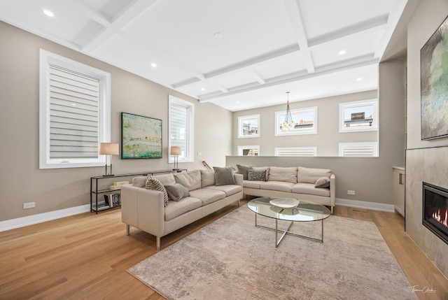 1642 W Wolfram St, Chicago, IL 60657 - living room featuring coffered ceiling, light wood-type flooring, a tiled fireplace, recessed lighting, and beam ceiling