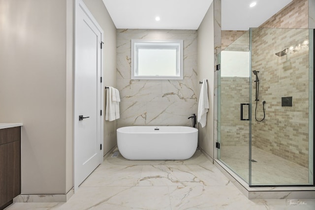 1642 W Wolfram St, Chicago, IL 60657 - full bath with a soaking tub, marble tiled floors, a stall shower, vanity, and recessed lighting