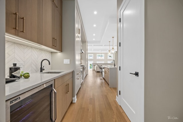 1642 W Wolfram St, Chicago, IL 60657 - kitchen featuring wine cooler, tasteful backsplash, modern cabinets, light countertops, and recessed lighting