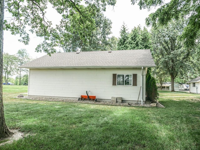 26 N Deer Lk, Villa Grove, IL 61956 - rear view of house featuring a lawn and roof with shingles